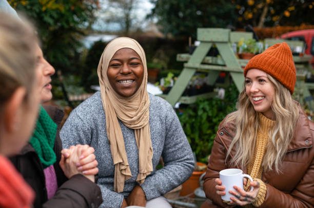 Phiona Hutton Counsellor and Integrative therapist, in person Havant, Hampshire or online nationwide. Group of four women chatting, enjoying a garden setting in autumn attire.