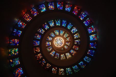 Phiona Hutton Counsellor and Integrative therapist, in person Havant, Hampshire or online nationwide. Spiral of colourful stained glass windows forming a vibrant circular pattern.