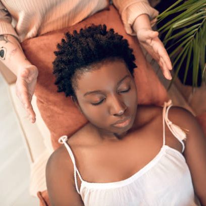 Usui Shiki Ryoho Reiki Training A person receiving a relaxation treatment with hands positioned over them.