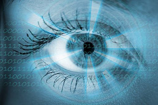 IEMT Close-up of a human eye with digital elements and binary code overlay.