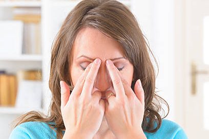 Phiona Hutton Counsellor and Integrative therapist, in person Havant, Hampshire or online nationwide. Woman performing a facial massage by pressing her forehead with her fingers.